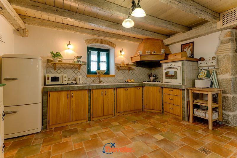 Holiday villa with pool in Croatia, rustically decorated kitchen with oven and refrigerator