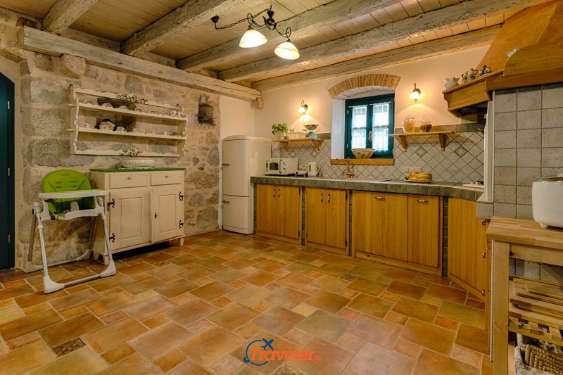 Holiday villa with pool in Croatia, rustically decorated kitchen with oven and refrigerator