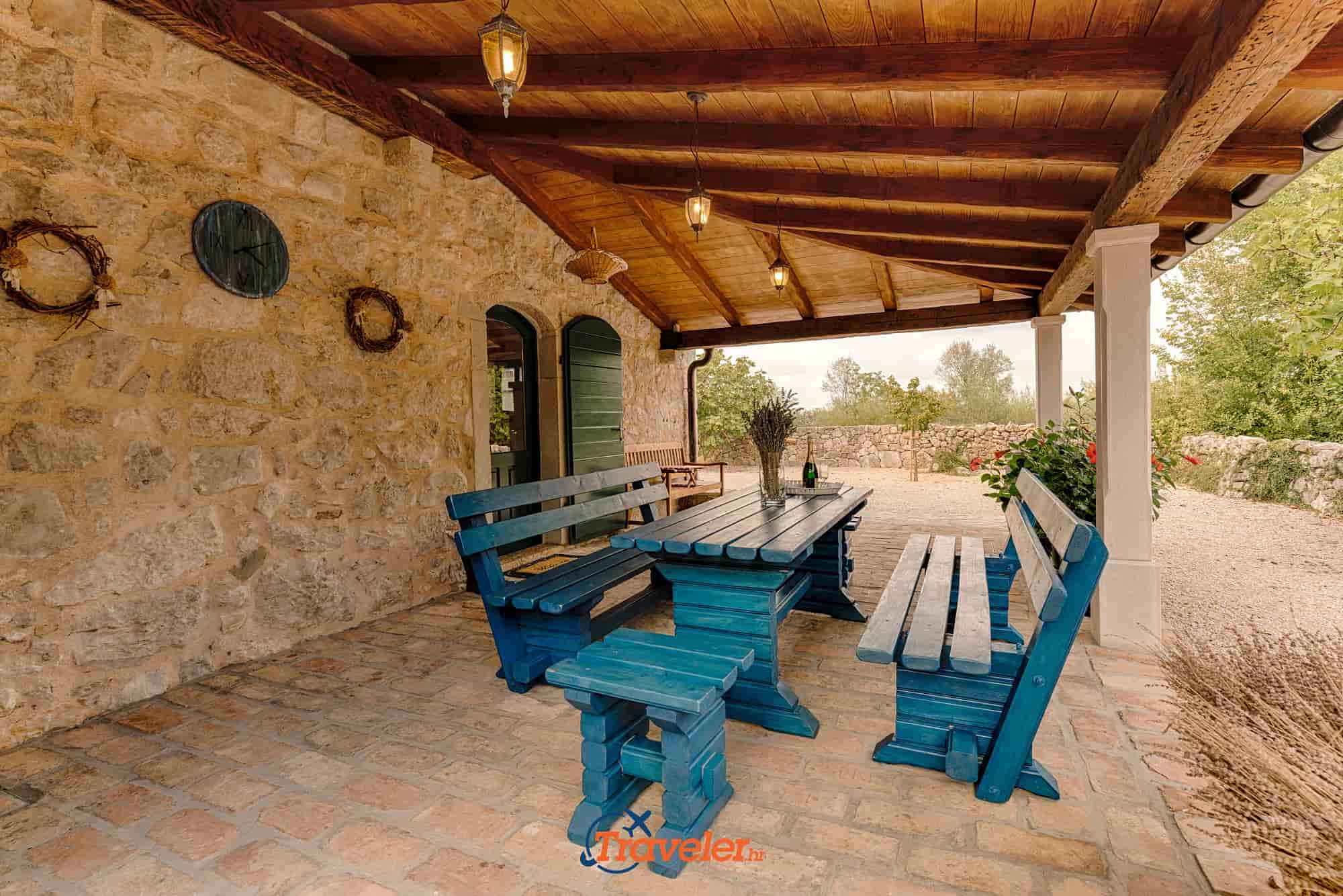 Holiday villa with pool in Croatia, wooden table and benches for dining