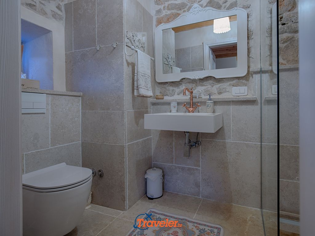 Badezimmer mit Waschbecken, WC und Dusche im rustikalen Stil